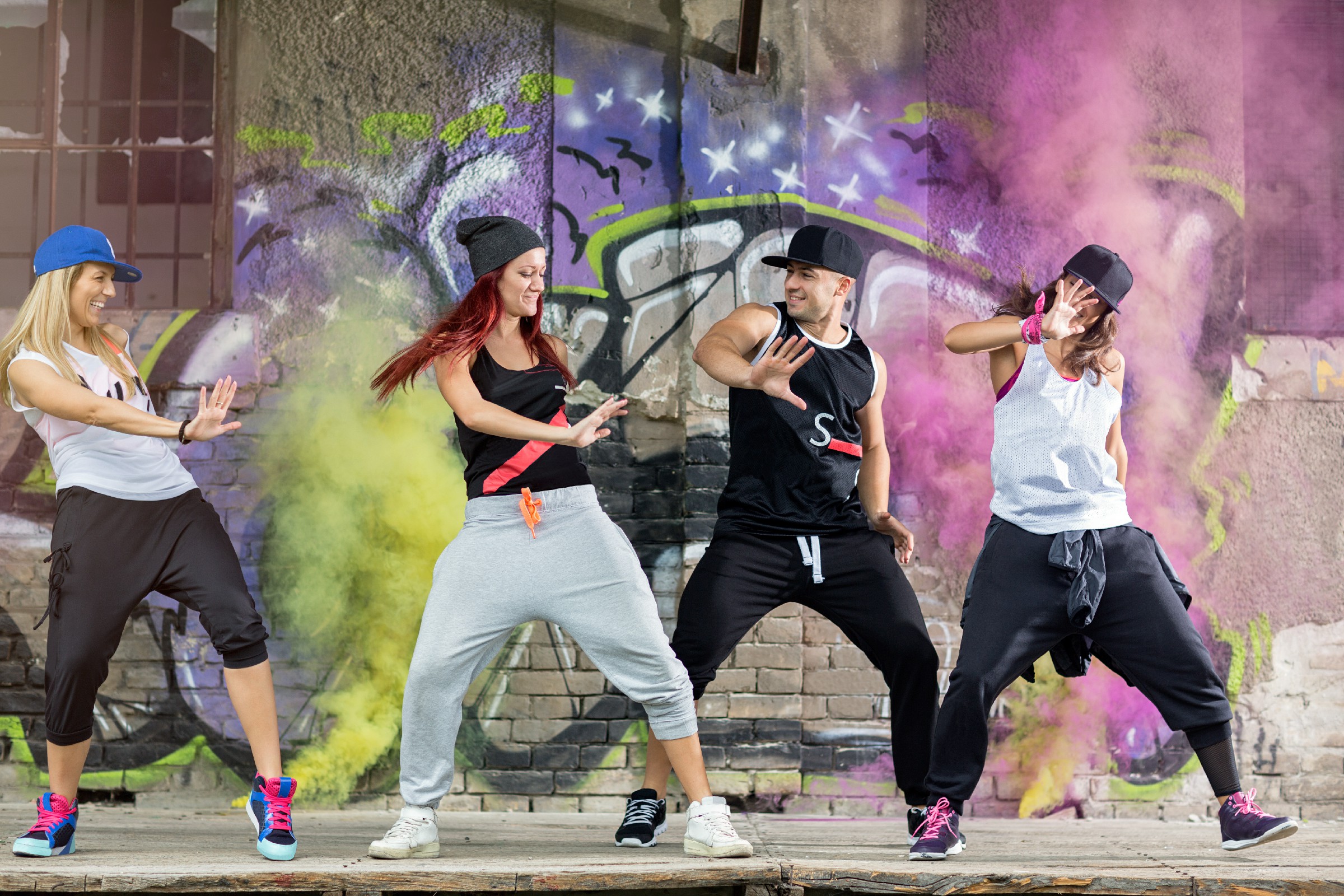 Young,Modern,Dancing,Group,Practice,Dancing,In,Front,Colorful,Wall